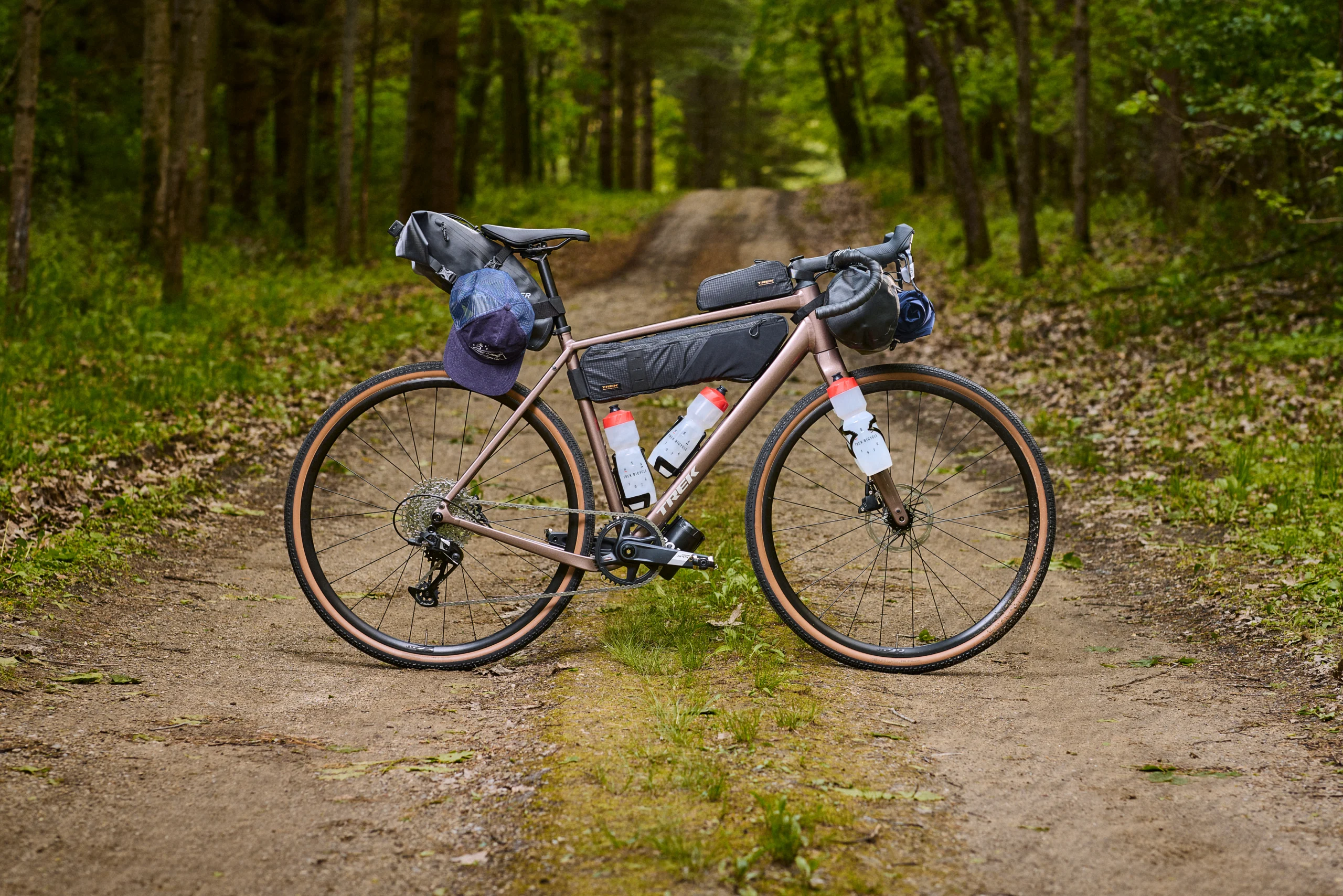 Ciclista pedalando uma Trek Checkpoint em estrada de terra